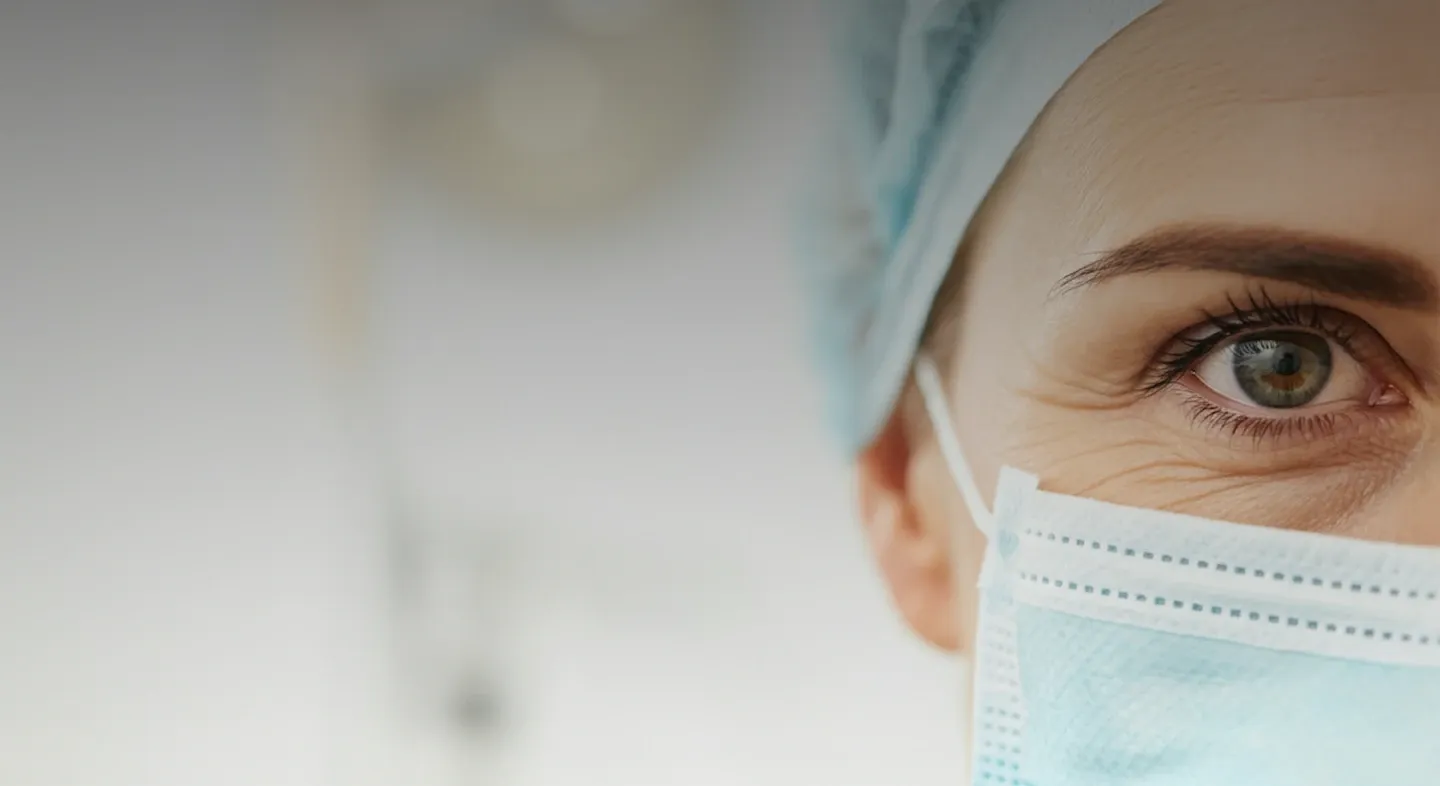 A surgeon in a mask and cap